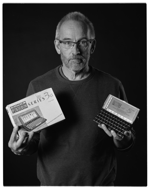 Portrait of the writer with a selection of Psion organisers