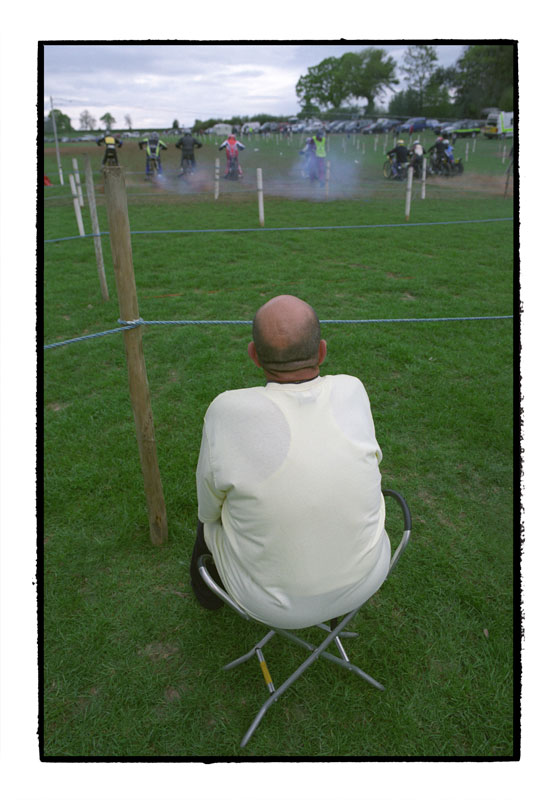 Man watching grasstrack motorcycle racing, Herefordshire 2007