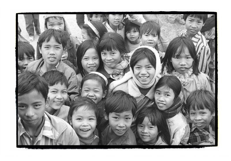 Children cluster around the film crew as we turn up to shoot part of a Nescafe commercial, North of Hanoi, 1999